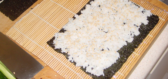 Sushi rice on the nori with sesame seeds
